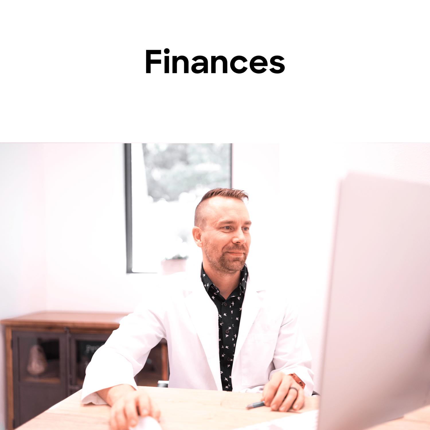 Finances- dentist sitting in front of a computer